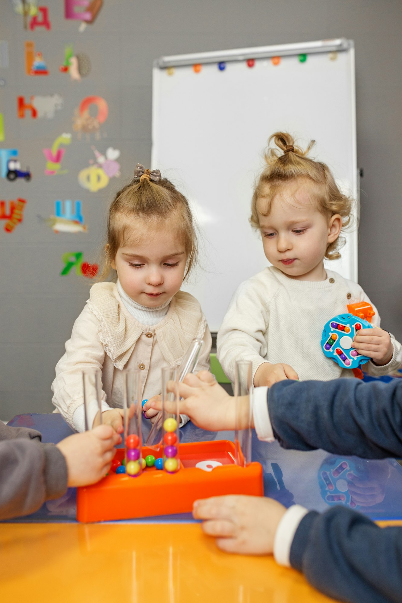 Children Engaged in Educational Play with Beads